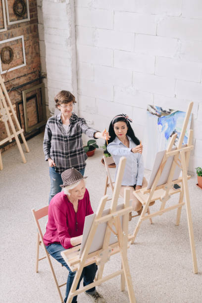 istock Female Art Teacher Working with Students 1039587198