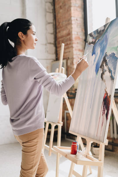 istock Beautiful Woman Painting in Studio 1039587292