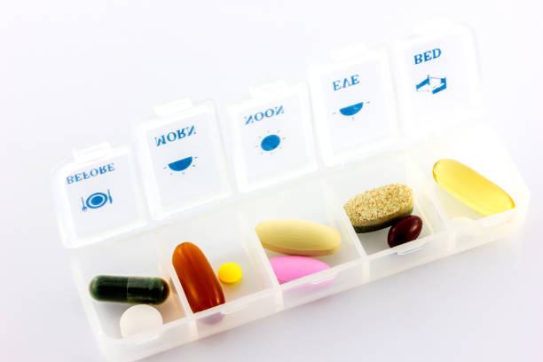 istock pills and vitamins in white pill box 1039595676