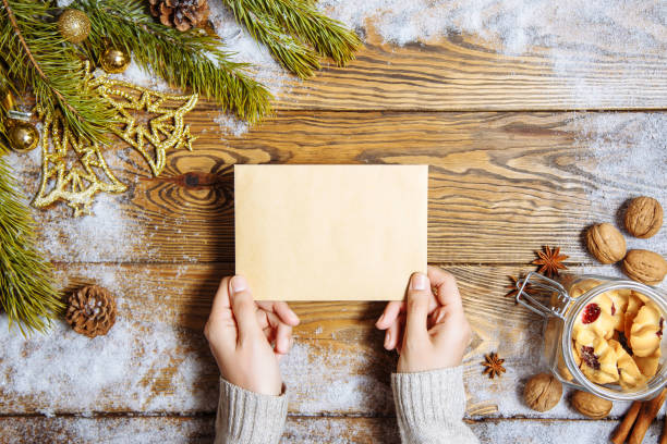 istock Female hands holding a greeting card. Christmas background. Copy space. 1039601164