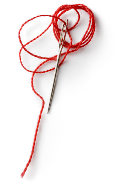 textile: red thread and needle isolated on white background - thread needle sewing red imagens e fotografias de stock