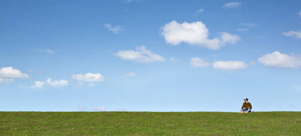 istock Man on a spacious meadow with a blue sky 1039615858