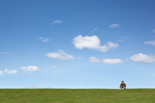 istock Man on a spacious meadow with a blue sky 1039615920
