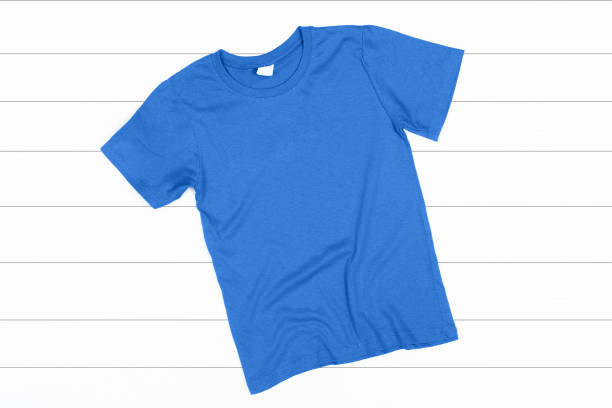 istock Blue T-Shirt on a White Wooden Background 1039623998