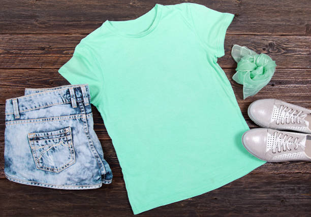 istock Mint T-shirt on a Dark Wooden Background 1039624076