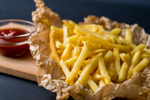 istock fried potatoes on wrapping paper with ketchup 1039626906