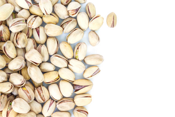 istock pistachio top view frame or border on white background. 1039635906
