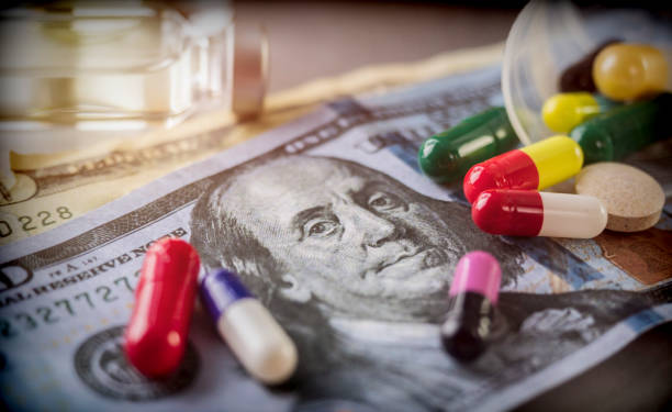 Some medications on a ticket of dollar, conceptual image copay health stock photo