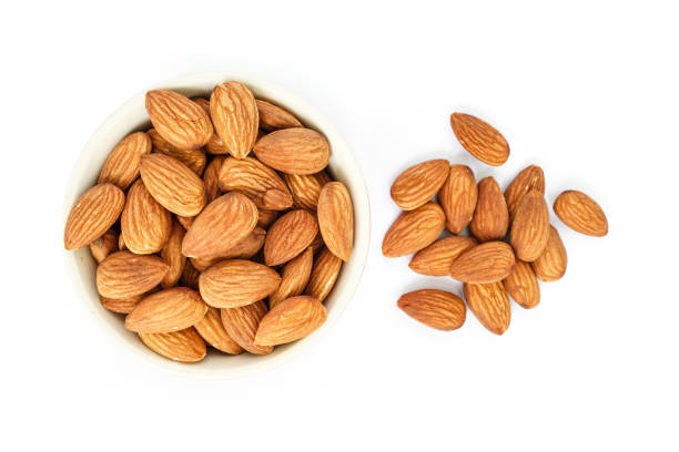 istock almonds in white bowl top view on white background. 1039636950
