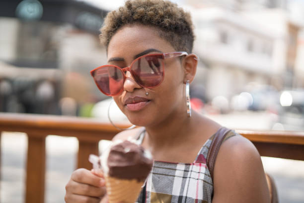 istock Young Woman Tasting Ice Cream Portrait 1039636996