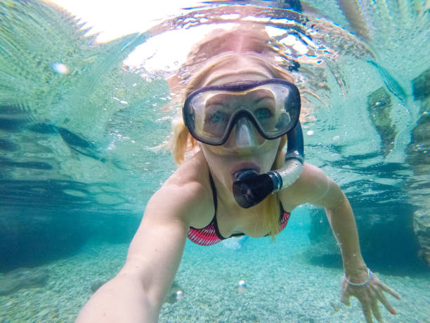 istock Young woman diving underwater 1039637008