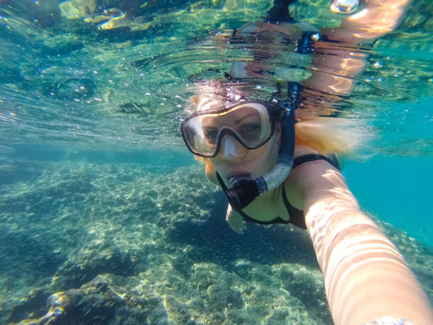 istock Young woman diving underwater 1039639952