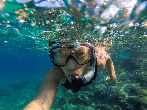 istock Young woman diving underwater 1039640108
