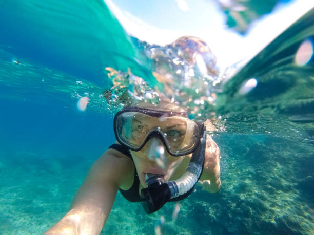 istock Young woman diving underwater 1039640230