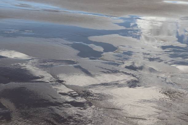istock Reflections of clouds on water in beach 1039642090