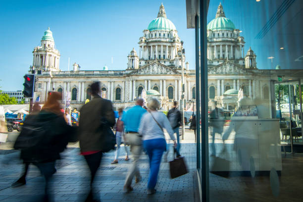 Belfast high street and city hall Motion blurred shoppers in front of Belfast city hall in Northern Ireland belfast stock pictures, royalty-free photos & images