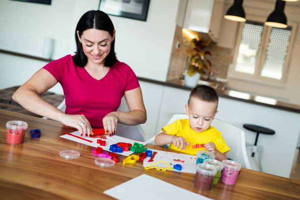 istock Mom and son with clay dough 1039656770