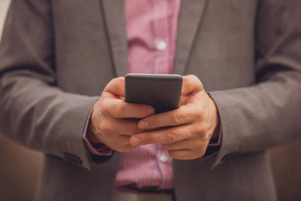 istock Modern business man using cellphone outdoors. 1039657726