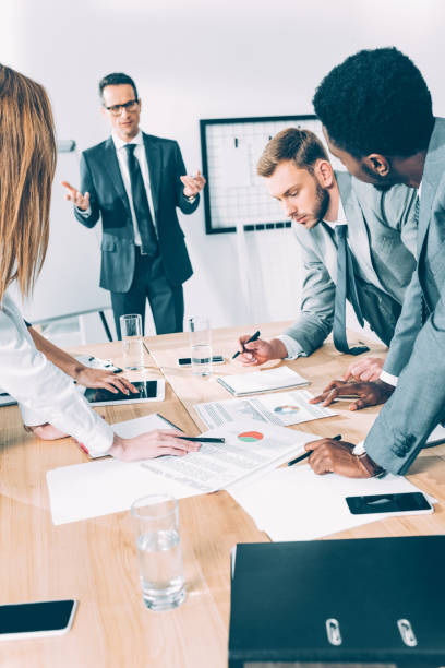 istock group of multiethnic business partners having conversation at conference hall 1039664274