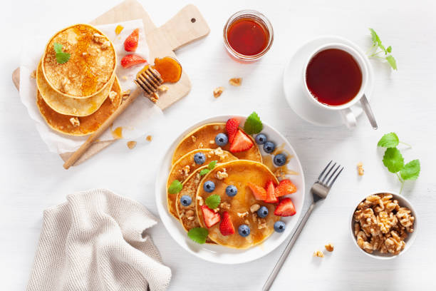 istock pancakes with blueberry strawberry honey and nuts for breakfast 1039681698