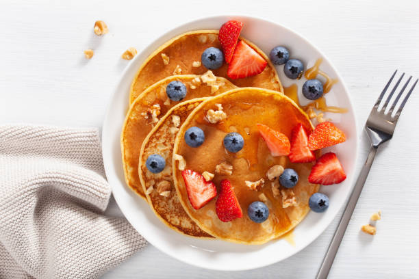 istock pancakes with blueberry strawberry honey and nuts for breakfast 1039682194