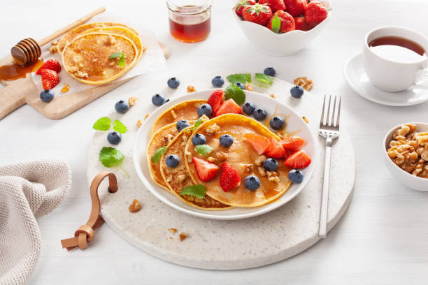istock pancakes with blueberry strawberry honey and nuts for breakfast 1039682394