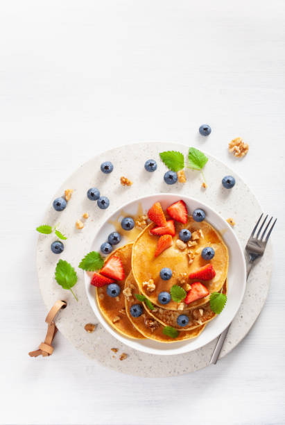 istock pancakes with blueberry strawberry honey and nuts for breakfast 1039682562