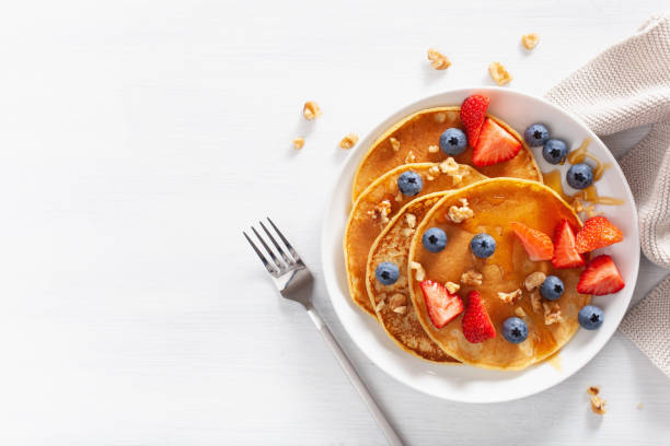 istock pancakes with blueberry strawberry honey and nuts for breakfast 1039683060