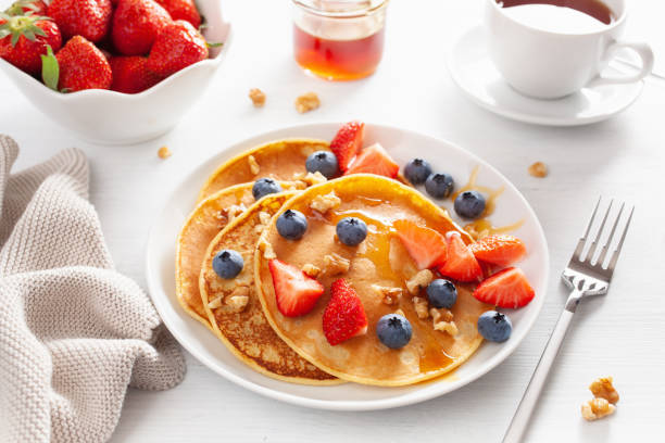 istock pancakes with blueberry strawberry honey and nuts for breakfast 1039683174