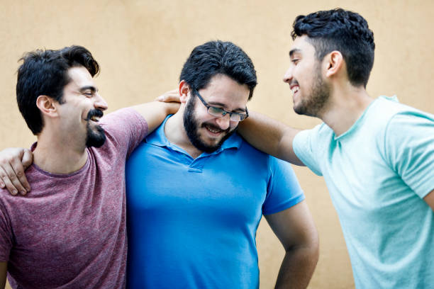 istock Young friends happily hugging each other at a party 1039683186