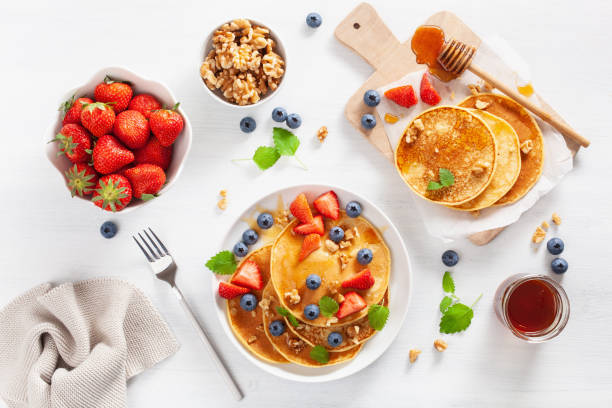 istock pancakes with blueberry strawberry honey and nuts for breakfast 1039683468