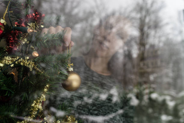 istock Young woman decorating Christmas tree 1039693590