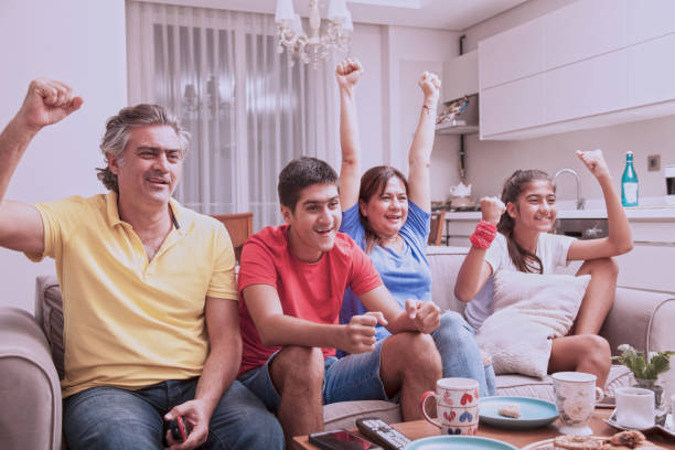 istock family watching tv 1039701378