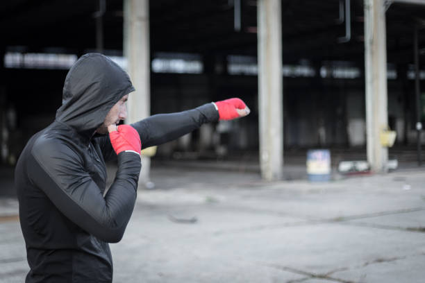istock Athletic man doing boxing training in abandoned factory 1039704384