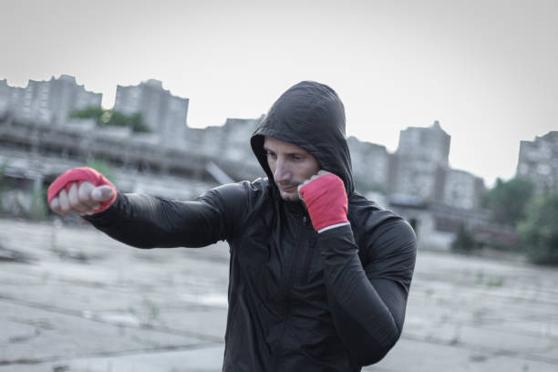 istock Athletic man doing boxing training in abandoned factory 1039704696