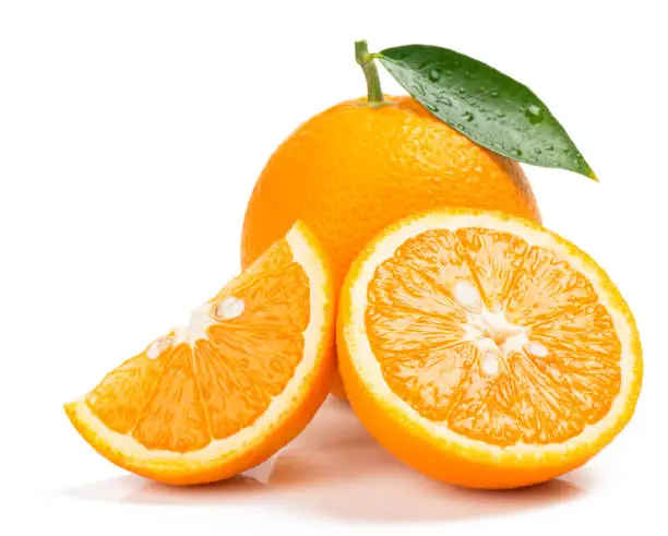 Photo of Orange whole, half and slice. Close up.