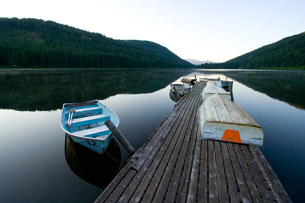 istock Serene lake at dawn with rowboats 103970955