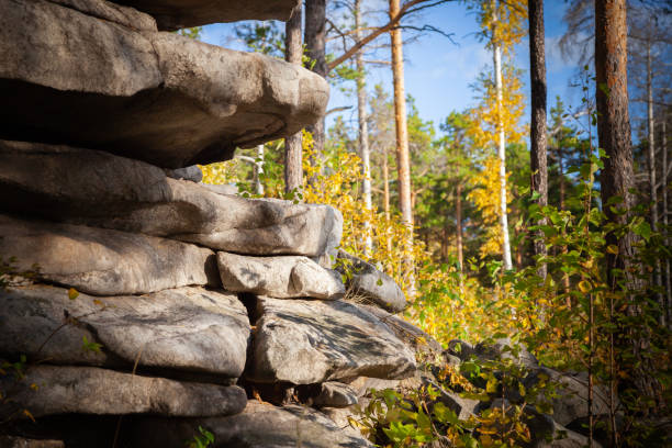 istock rocks against the blue sky and forest 1039709584