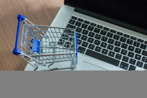 istock Trolley on a laptop. Buy online concept 1039711096