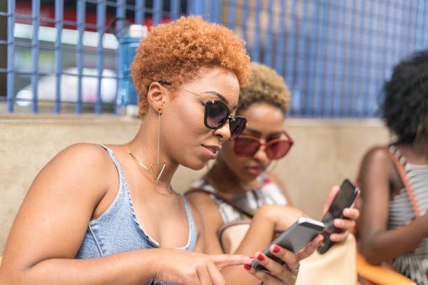 istock Afro Young Women Using Mobile in The Subway 1039721342