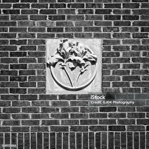 Concrete Flower On Red Brick Wall Bw Stock Photo - Download Image Now - Abstract, Architecture, Art