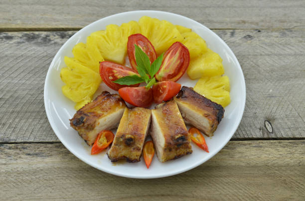 istock Delicious grilled ribs on plate, with vegetables 1039722510