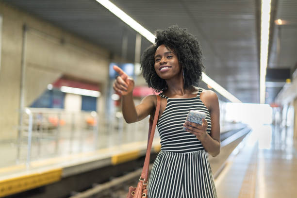 istock Afro Young Woman Using Mobile in The Subway 1039722956