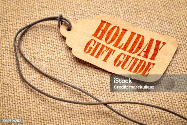 Holiday Gift Guide Text On A Price Tag Stock Photo - Download Image Now - Guide - Occupation, Gift, Holiday - Event