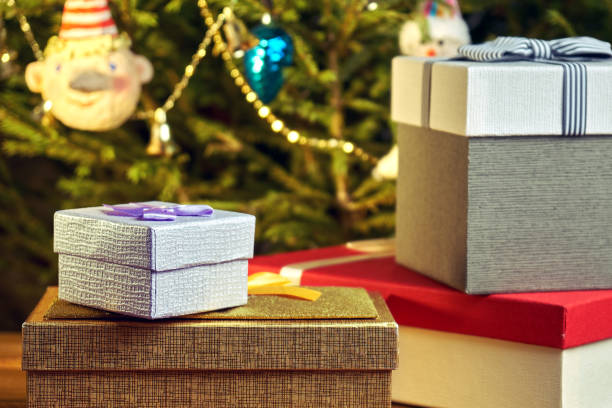 istock Gift boxes with bows on the lids under a Christmas tree in New Year Eve 1039726518
