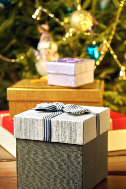 istock Gift boxes with bows on the lids under a Christmas tree in New Year Eve 1039726602