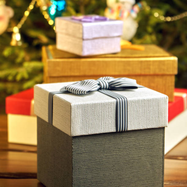 istock Gift boxes with bows on the lids under a Christmas tree in New Year Eve 1039726666