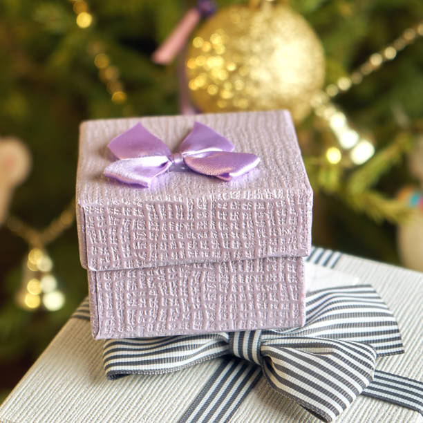 istock Gift boxes with bows on the lids under a Christmas tree in New Year Eve 1039727158