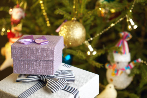 istock Gift boxes with bows on the lids under a Christmas tree in New Year Eve 1039727416