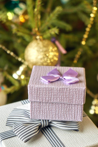 istock Gift boxes with bows on the lids under a Christmas tree in New Year Eve 1039727758